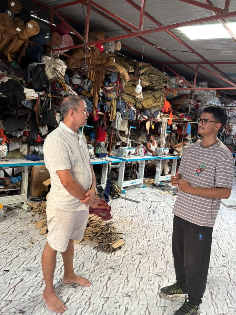 Nabaraj Adhikari speaking with an Unfold Nepal researcher inside his handloom bag production workshop in Kathmandu